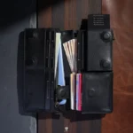 Open leather wallet showing cash compartment and phone pocket