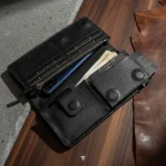 Open leather wallet showing cash compartment and phone pocket