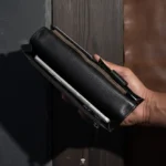Open leather wallet showing cash compartment and phone pocket