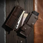 Open leather wallet showing cash compartment and phone pocket
